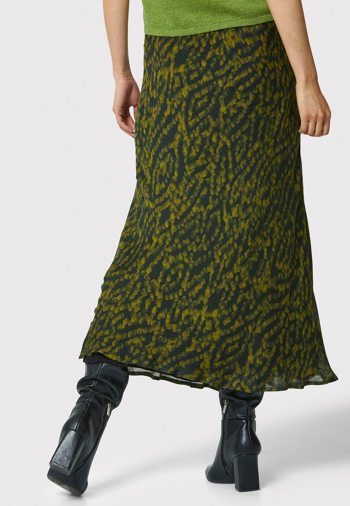 Add a touch of elegance to your wardrobe with the bias-cut dark green forest print skirt. Crafted from a luxurious blend of viscose and silk, it features a fluid silhouette that drapes beautifully. The unique pattern and midi length make it a versatile piece, perfect for both day and night. Pair with our black timeless tops and boots for a chic, modern look or make a statement by pairing with the Marlena Chartreuse green sleeveless cashmere top.