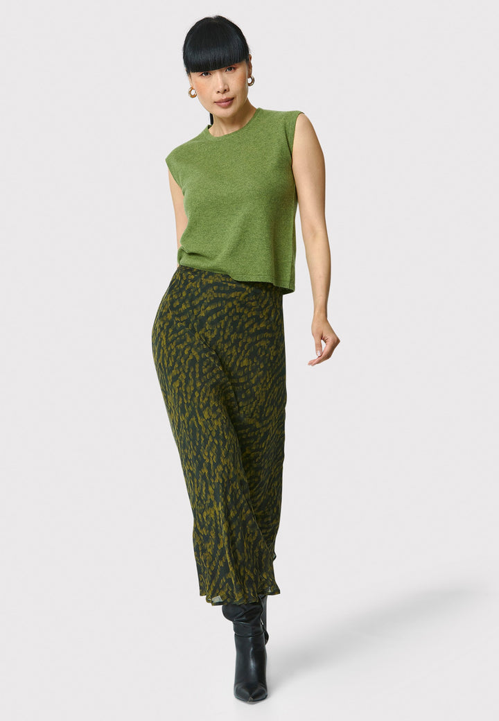 Add a touch of elegance to your wardrobe with the bias-cut dark green forest print skirt. Crafted from a luxurious blend of viscose and silk, it features a fluid silhouette that drapes beautifully. The unique pattern and midi length make it a versatile piece, perfect for both day and night. Pair with our black timeless tops and boots for a chic, modern look or make a statement by pairing with the Marlena Chartreuse green sleeveless cashmere top.