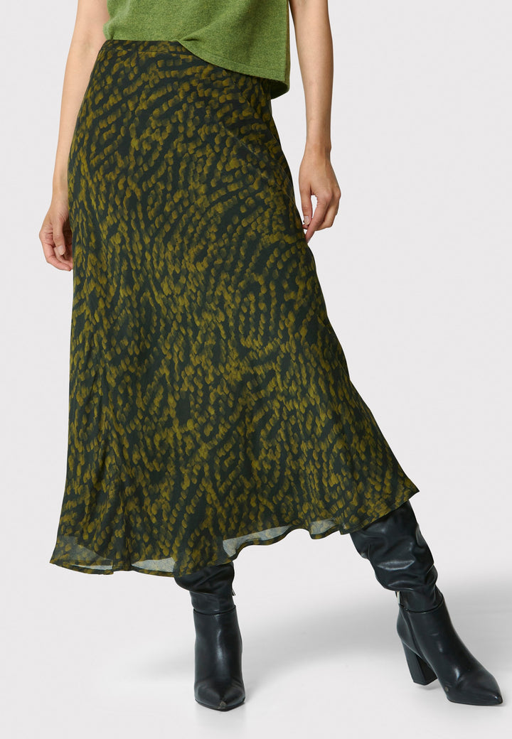 Add a touch of elegance to your wardrobe with the bias-cut dark green forest print skirt. Crafted from a luxurious blend of viscose and silk, it features a fluid silhouette that drapes beautifully. The unique pattern and midi length make it a versatile piece, perfect for both day and night. Pair with our black timeless tops and boots for a chic, modern look or make a statement by pairing with the Marlena Chartreuse green sleeveless cashmere top.