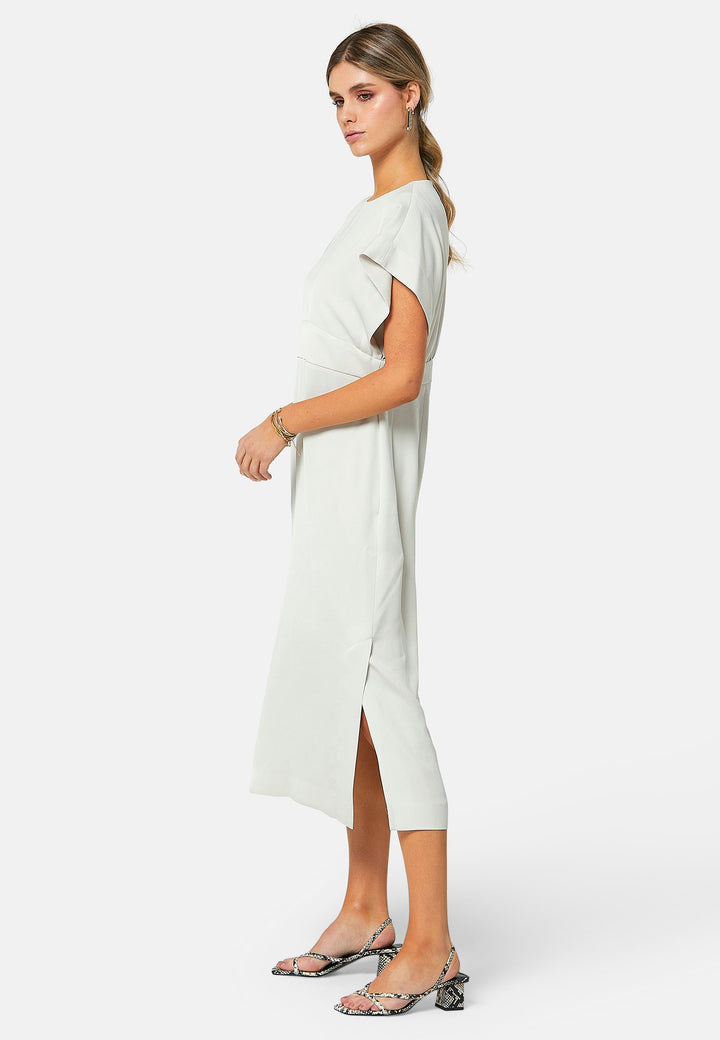 Elevate your wardrobe with Shiv, a simple stone midi dress in a fluid satin back crepe. Featuring dropped sleeves, a gathered back waist seam, and a side slit for ease of movement. The back has a keyhole detail with a button closure.