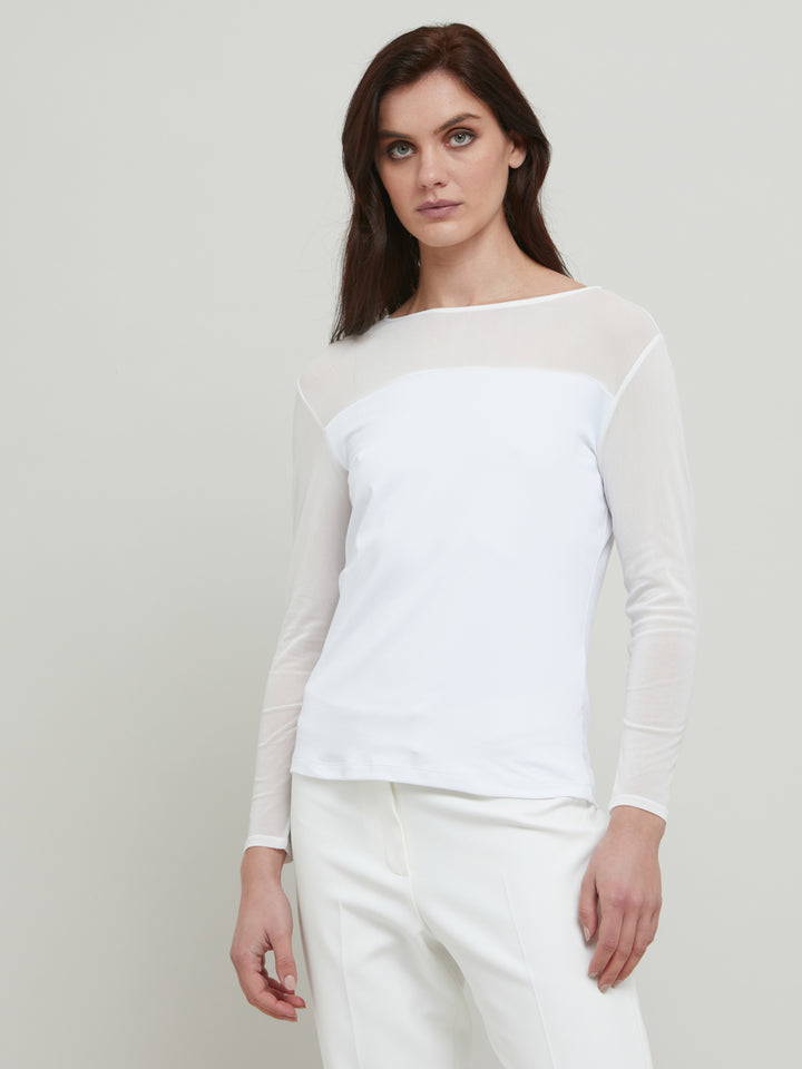 A signature hmca piece. our perennial best-seller back in white. This versatile top features a flattering mesh yoke and sleeves on a snug jersey body. Perfect underpinning to suiting or a more casual pant. Designed by Helen McAlinden in Ireland and made to last in Europe.