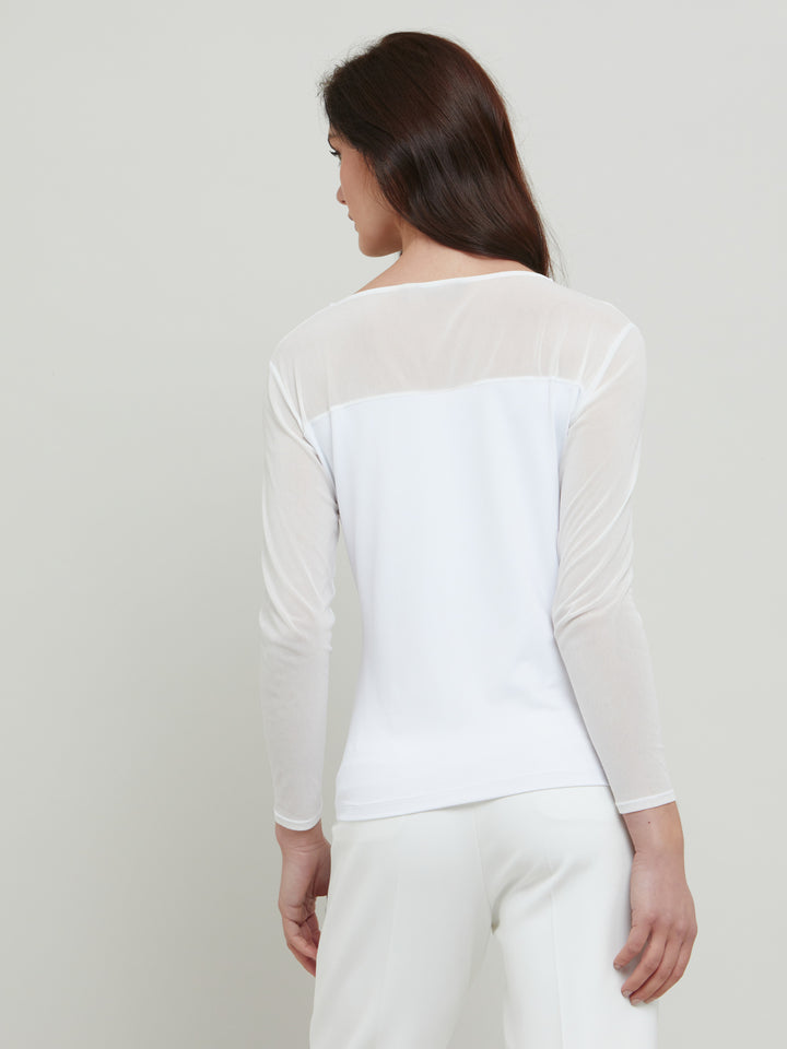 A signature hmca piece. our perennial best-seller back in white. This versatile top features a flattering mesh yoke and sleeves on a snug jersey body. Perfect underpinning to suiting or a more casual pant. Designed by Helen McAlinden in Ireland and made to last in Europe.