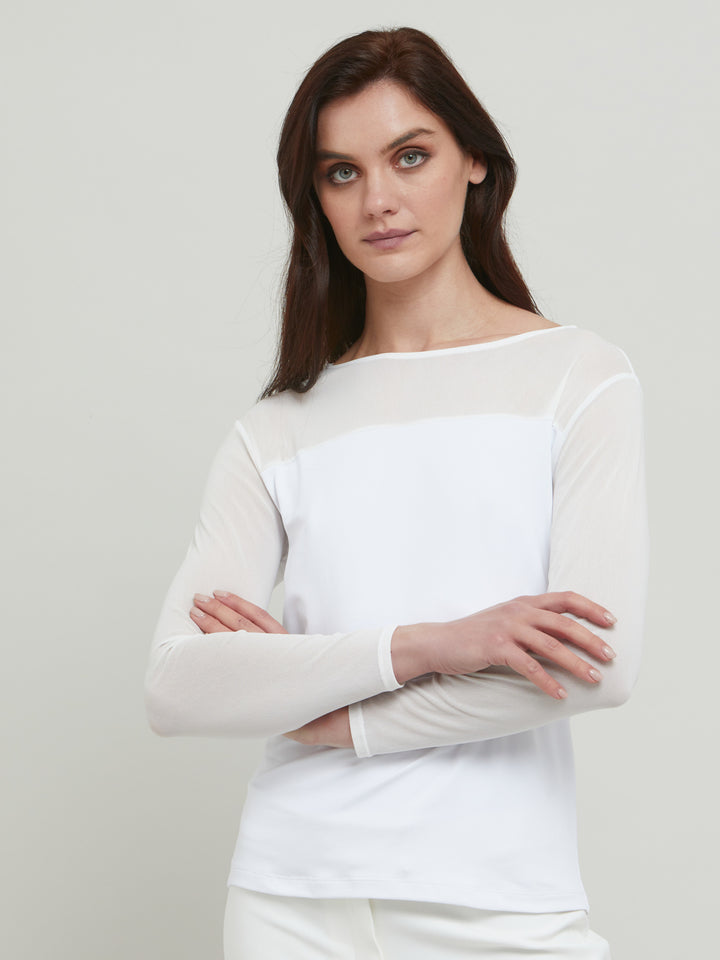 A signature hmca piece. our perennial best-seller back in white. This versatile top features a flattering mesh yoke and sleeves on a snug jersey body. Perfect underpinning to suiting or a more casual pant. Designed by Helen McAlinden in Ireland and made to last in Europe.