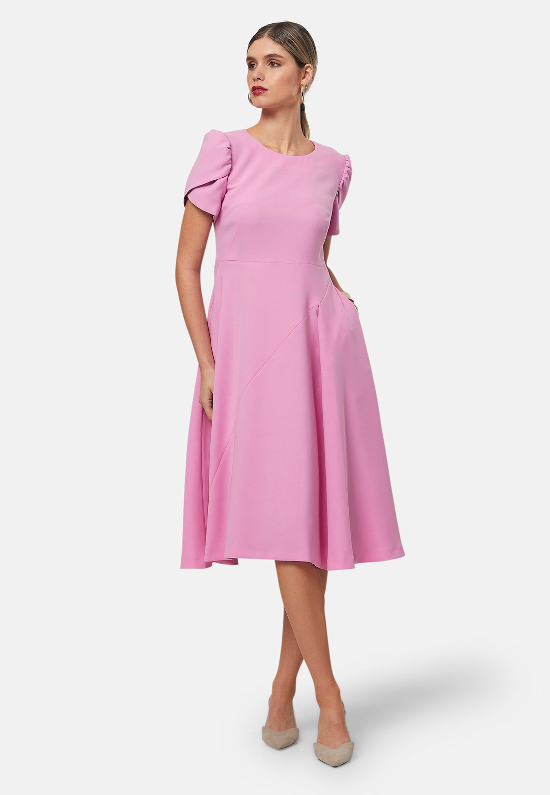 The Vera midi dress in a feminine pink hue features a flattering fit-and-flare silhouette. With short, puffed sleeves and subtle seam details. Crafted from our signature tricotine with a touch of elastane to ensure ease of movement. Perfect for formal luncheons, weddings or evening outings.