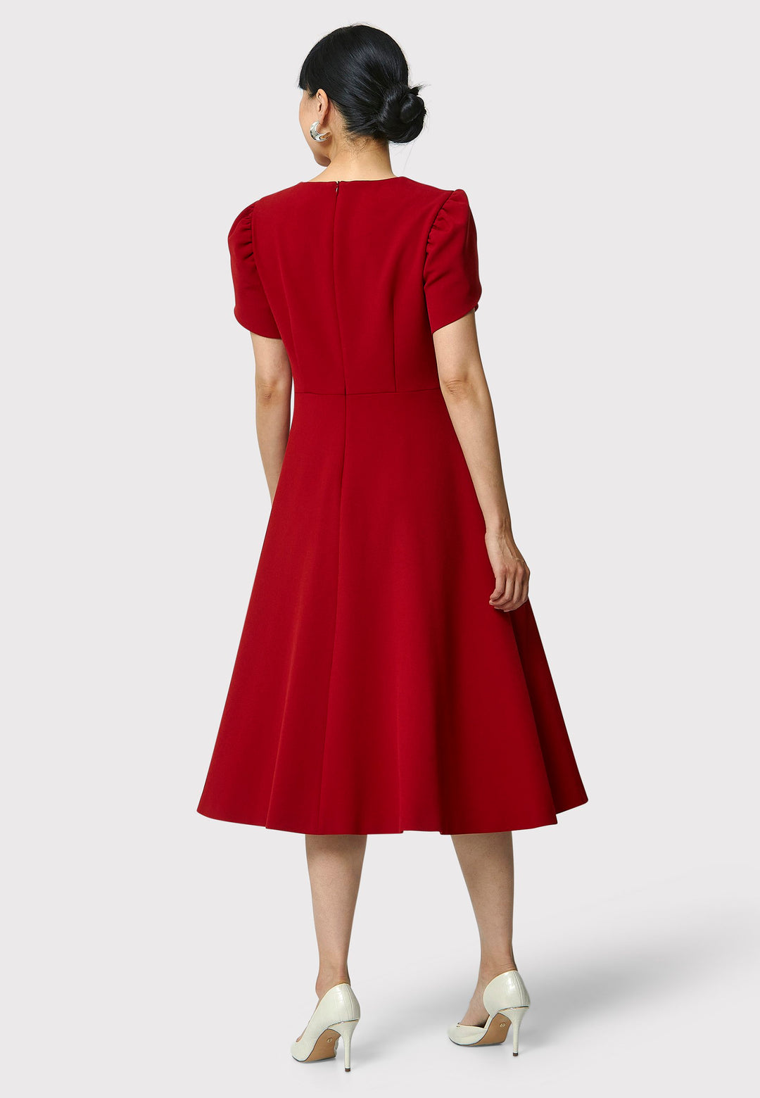 The Vera Garnet Red Dress is perfect for special occasions. It features a flattering fit-and-flare silhouette, a round neckline, and short puffed sleeves. The mid-calf length skirt flares out gracefully, adding elegance to the dress. Crafted from a comfortable fabric blend, it ensures ease of movement and a polished look.