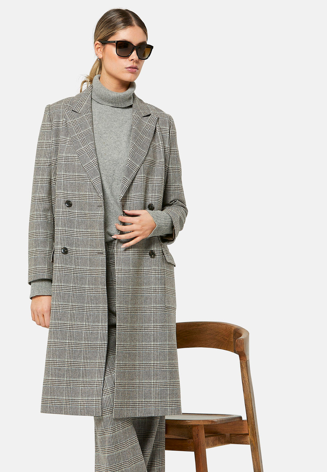 Introducing the Victoria Coat, a contemporary silhouette crafted in Magee lamsbwool. This double-breasted coat, featuring patch pockets and falls below the knee, it exudes timeless sophistication. The Victoria Coat elevates your transition and winter wardrobe.