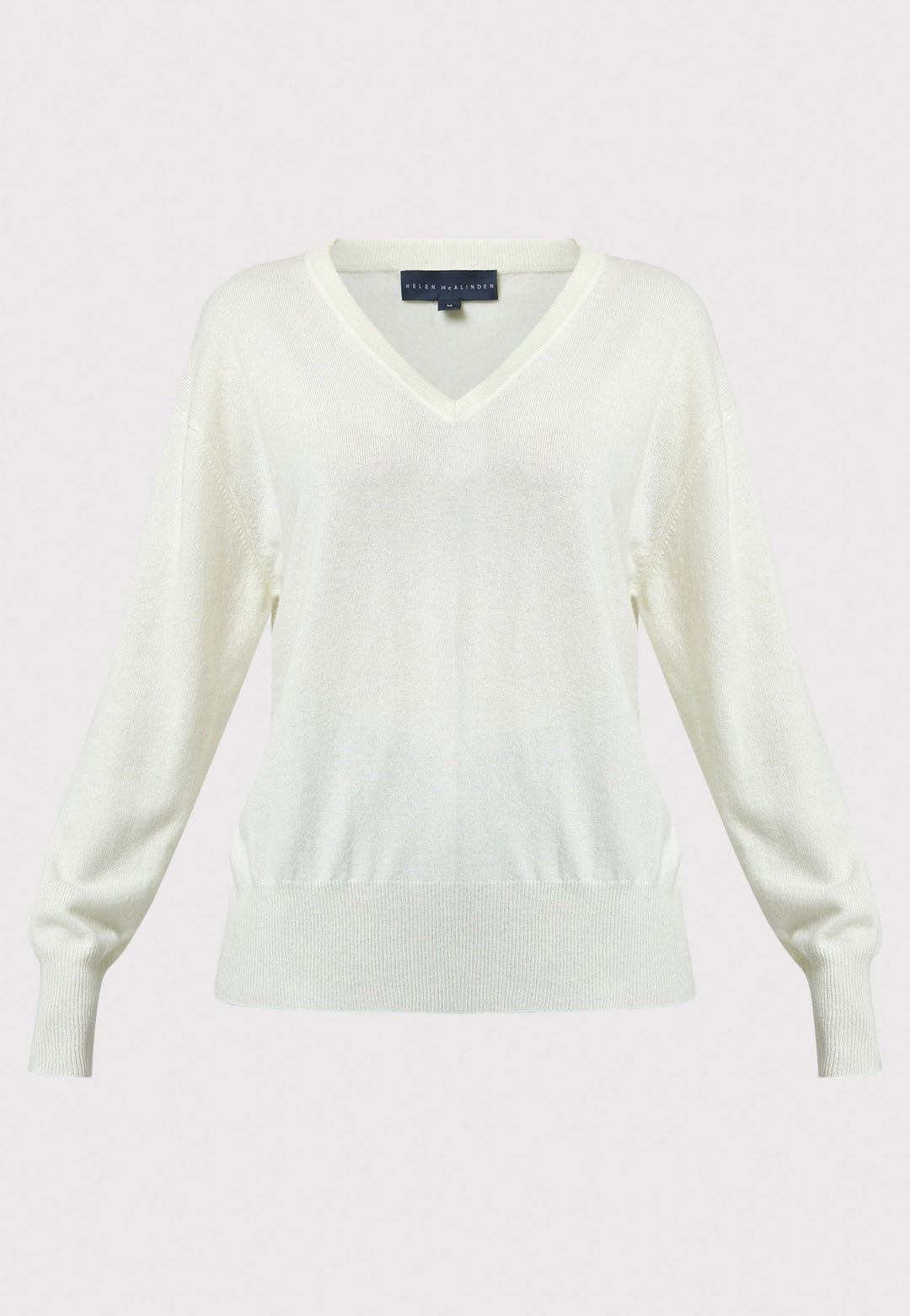 The Viv V-neck Cream Sweater is a luxurious blend of extra fine merino wool and cashmere, ensuring a soft and warm experience. 