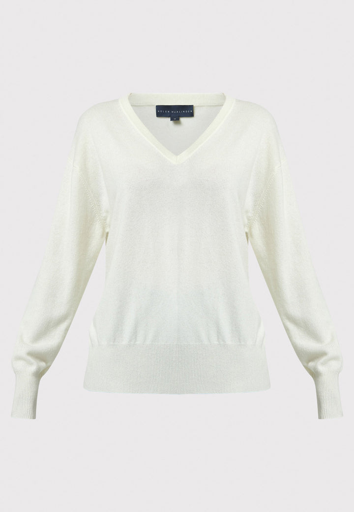 The Viv V-neck Cream Sweater is a luxurious blend of extra fine merino wool and cashmere, ensuring a soft and warm experience. 