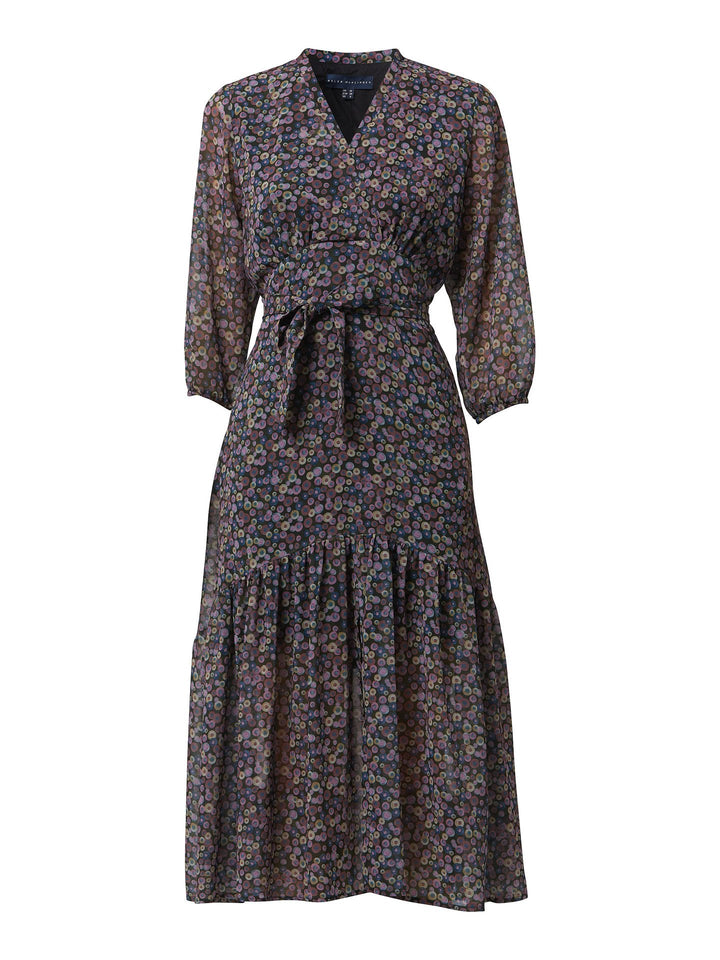 Opt for beverly, the ultimate transeasonal dress. Crafted in a breathable viscose georgette with an irregular multi-coloured dot print. The design is rooted in simplicity with a cross over v-neckline and flattering waist ties. The voluminous semi-sheer sleeves subtly balance the traditional design for a fresh, feminine look