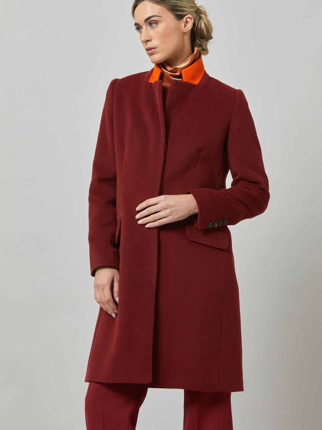 Lisa, practical winter glamour at its finest. Crafted in a warm russet red melton with a tidy collar & revere. Lisa features handy jeet pockets & concealed buttons. This knee-length coat ensures stylish winter warmth.