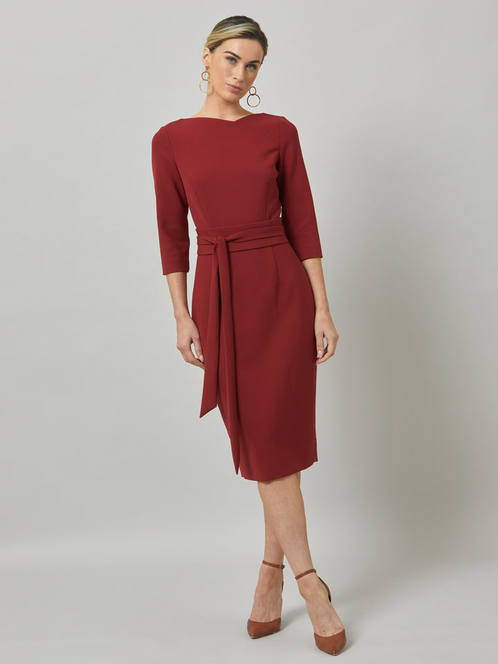 Rema, a warm russet red body-con dress. Features an elegant asymmetric vee neckline which is echoed in it's detachable no -fuss obi belt. The elastic in the fabric ensures comfort and ease of movement. Elegant and timeless with relaxed mood for the modern woman. 