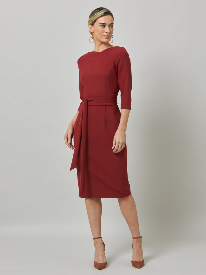 Rema, a warm russet red body-con dress. Features an elegant asymmetric vee neckline which is echoed in it's detachable no -fuss obi belt. The elastic in the fabric ensures comfort and ease of movement. Elegant and timeless with relaxed mood for the modern woman. 