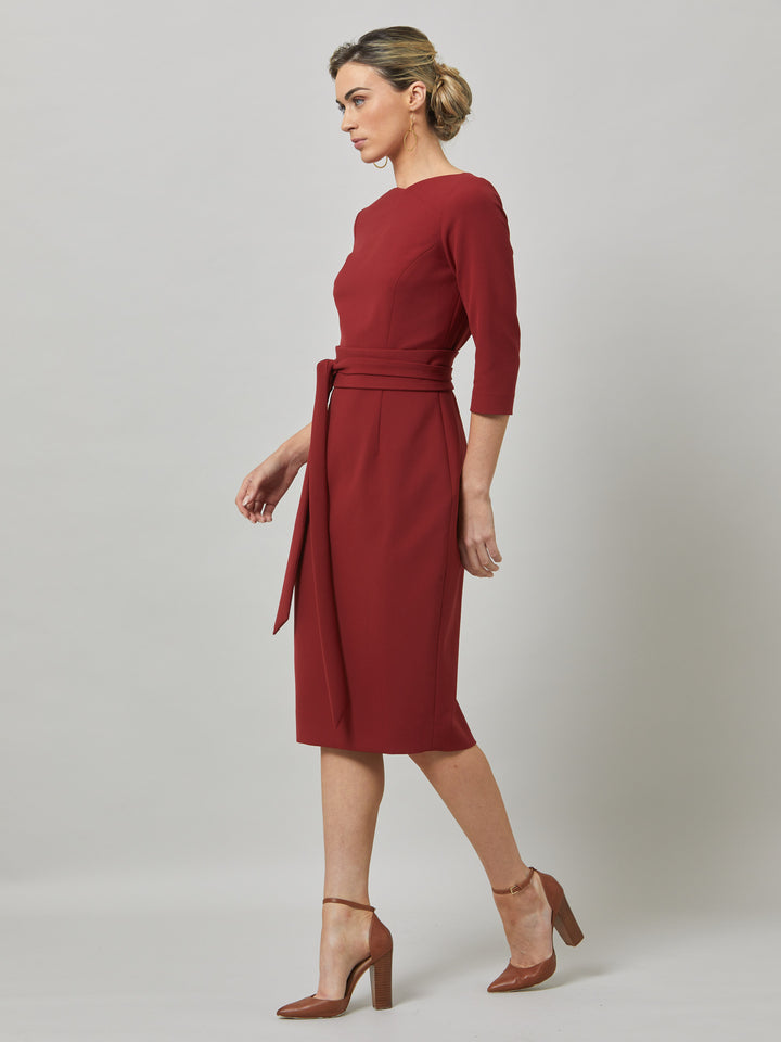 Rema, a warm russet red body-con dress. Features an elegant asymmetric vee neckline which is echoed in it's detachable no -fuss obi belt. The elastic in the fabric ensures comfort and ease of movement. Elegant and timeless with relaxed mood for the modern woman. 