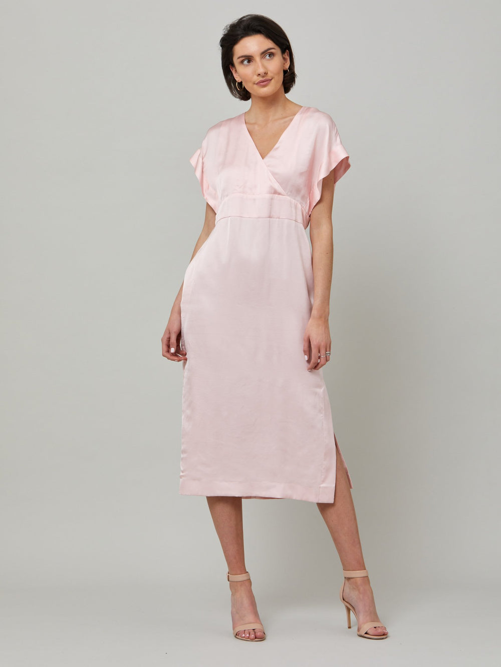 Classic occasion wear, modernized. Meet the Fleur dress in luxurious blossom pink satin viscose. An easy-fitting silhouette with a V-neckline, falls to the mid-calf and features side slit, pockets, and an elegant key-hole back neck detail. Attending a summer wedding? Mother of the bride? Heading to the races? This is the dress for you.